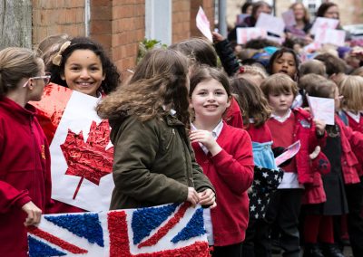 Smiling school children with flags in Church Street