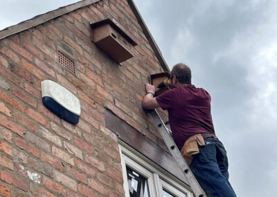 Chris Beaton installing Harbury Parish Council swift nest boxes 20 and 21